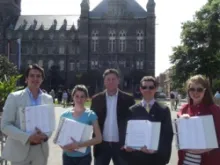 Thomas Peters of Catholic Vote and concerned members of the Georgetown community holds the four binders with more than 35,000 signatures.