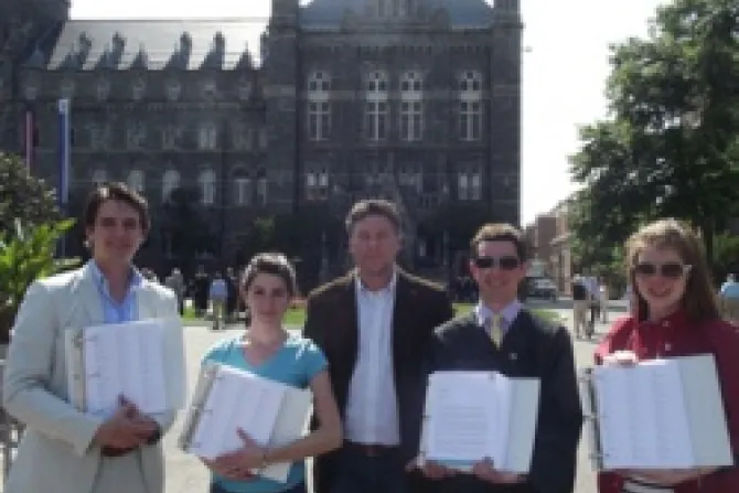 Thomas Peters of Catholic Vote and concerned members of the Georgetown community hols the 4 binders with more than 35000 signatures CNA US Catholic News 5 17 12