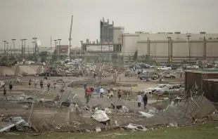 People walk through a damaged area near the Moore Warren Theater after a powerful tornado ripped through the area on May 20, 2013 in Moore, OK.   Brett Deering/Getty Images News/Getty Images.