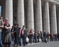 Tourists stand in line in St. Peter's Square as they wait to enter the basilica?w=200&h=150