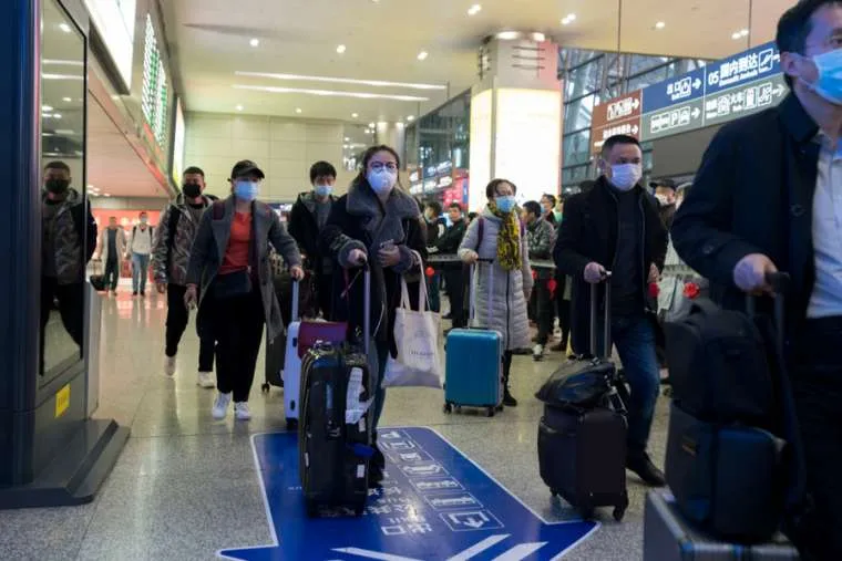 Travellers at an airport in Chengdu, China wear masks to prevent infection from coronavirus, Jan. 23, 2019. ?w=200&h=150
