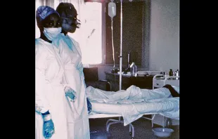 Two nurses and Ebola Case.   CDC/Lyle Conrad via Wikimedia.