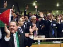 President Mahmoud Abbas (front center) of the Palestinian Authority celebrates recognition with his delegation in the General Assembly Hall on Nov. 29, 2012. 