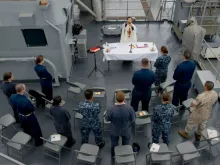 US Navy Chaplain Lt. Tung Tran says Mass aboard the USS Rushmore, June 21, 2014. 