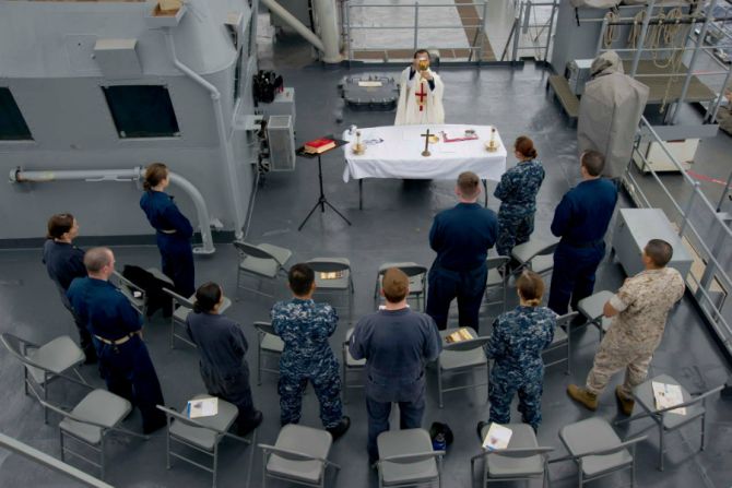 US Navy Chaplain Lt Tung Tran says Mass aboard the USS Rushmore June 21 2014 Credit US Navy photo by Mass Communication Specialist 3rd Class Dustin Knight Released CNA
