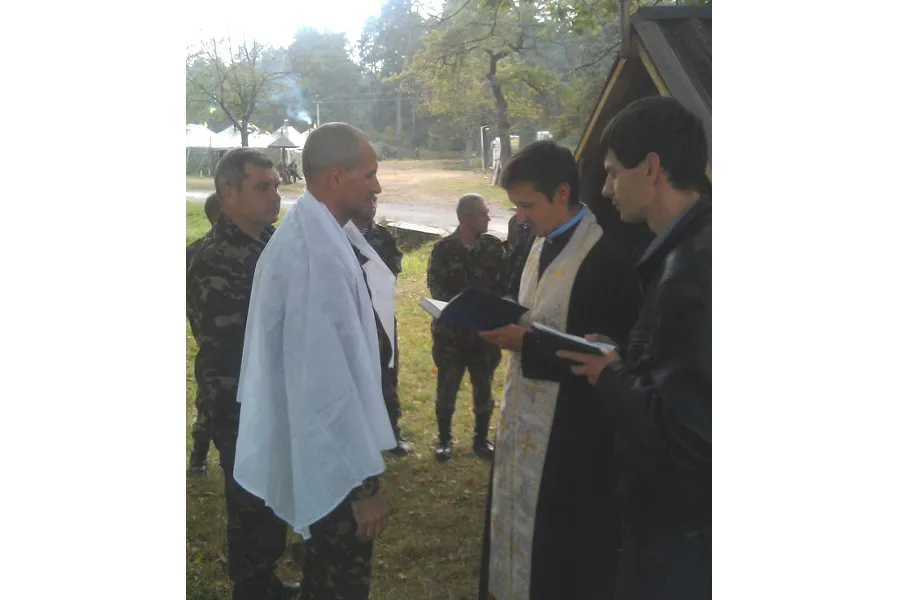 A soldier is baptized by a Ukrainian Catholic military chaplain.?w=200&h=150