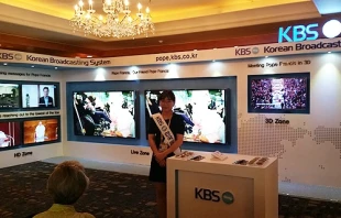University student Sun-Joo Pae assists international press at the KBS stand inside the media center at the Lotte Hotel in Seoul, South Korea.   Elise Harris/CNA.