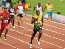 Usain Bolt of Jamaica approaches the finish line to win gold and set a new world record of 36.84 during the Men's 4x100m Relay Final, Aug. 11, 2012. 