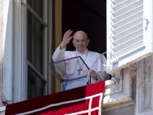 Pope Francis waves from his window overlooking St. Peter’s Square during an Angelus address. 