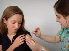 A teenager receives a vaccination. 