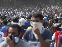 Anti-government protesters take part in a march in Caracas May 1, 2019 after clashes spurred by Juan Guaido's call on the military to rise up against Maduro. 