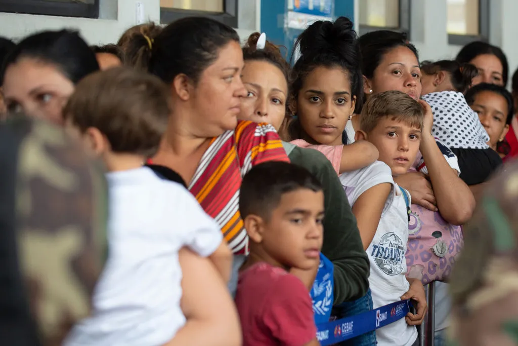 Venezuelan migrants wait to get a refugee application at the Peruvian border post at the binational border attention centre in Tumbes, June 14, 2019. ?w=200&h=150