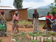 Women in Rwanda tend a community garden with techniques taught by Catholic Relief Services. 