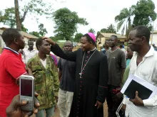 Archbishop Dieudonné Nzapalainga of Bangui, the Central African capital, blesses an ex-Seleka figher at Camp Beal. 