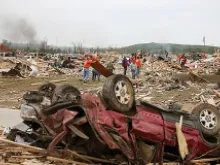Volunteers help clean up debris April 29, 2014 after a tornado ripped through Vilonia, Arkansas on April 27. 