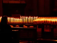 Woman with prayer candles. 