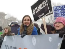 Women chant in the snow in support of religious liberty outside the Supreme Court building in Washington, D.C., March 25, 2014. 