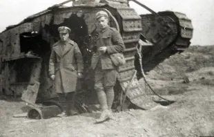 Two soldiers standing beside a World War One tank.   Manchester Archives via Flickr (CC BY-NC-SA 2.0).