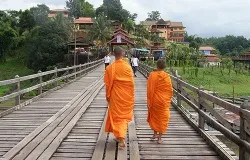 Young buddhist monks cross a bridge in Thailand. ?w=200&h=150
