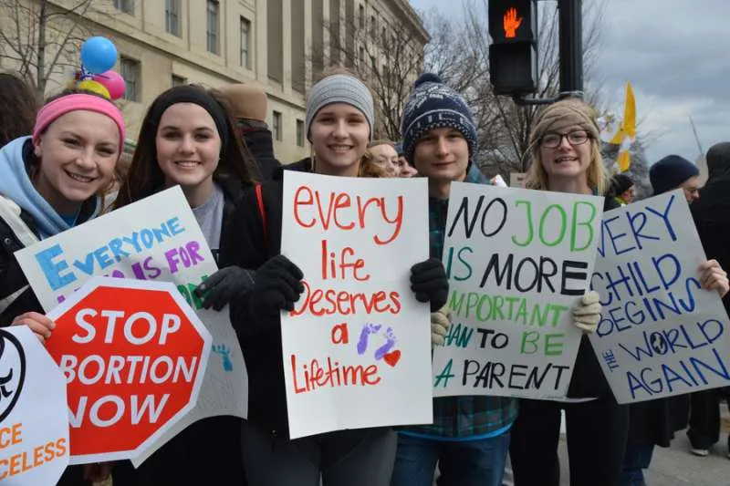 Young people hold signs opposing abortion during the March for Life in Washington, D.C. ?w=200&h=150