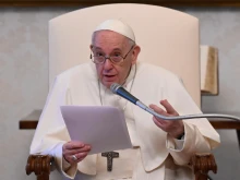 Pope Francis gives his general audience address in the library of the Apostolic Palace April 28, 2021.