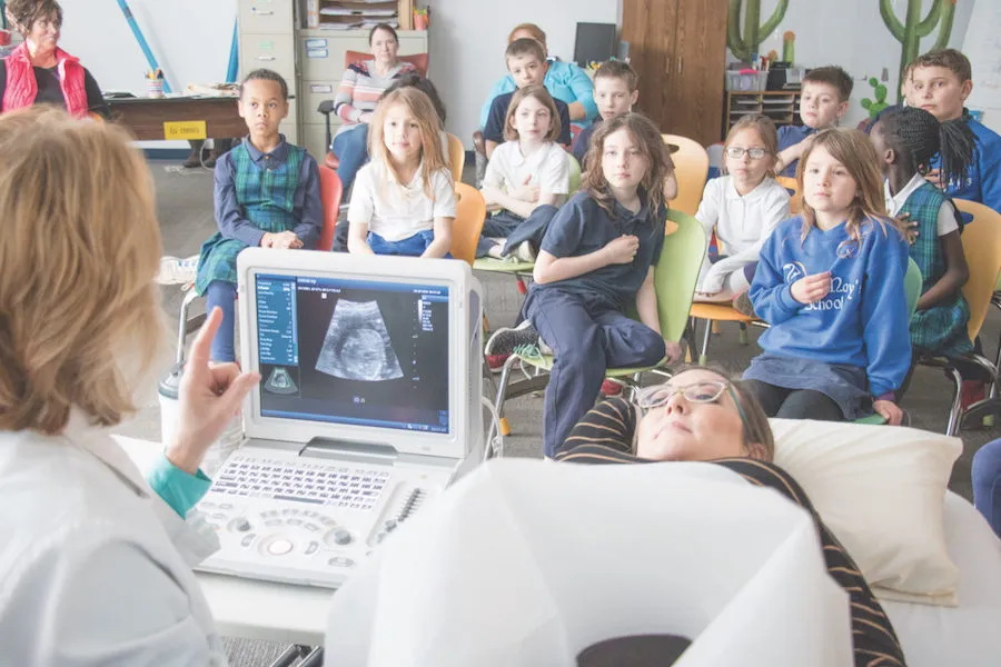 Second-graders at St. Mary School in Bellevue watch a live ultrasound presentation Feb. 28 showing the 21-week-old baby inside Kelly Miller. ?w=200&h=150