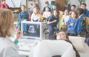 Second-graders at St. Mary School in Bellevue watch a live ultrasound presentation Feb. 28 showing the 21-week-old baby inside Kelly Miller.   Susan Szalewski/Catholic Voice 