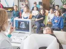Second-graders at St. Mary School in Bellevue watch a live ultrasound presentation Feb. 28 showing the 21-week-old baby inside Kelly Miller. 