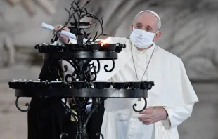 Pope Francis light a candle during an interreligious ceremony in the Campidoglio Square, Rome, Oct. 20, 2020.  
