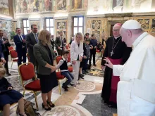Pope Francis waves to a child at an audience with representatives of the Ambulatorium Sonnenschein in St. Pölten, Austria. 