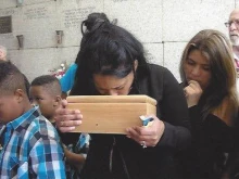 A family grieves their lost baby at a funeral at the crypt at St. Patrick’s Cemetery in New Orleans. Many friends, relatives, and families attended the funeral that day.