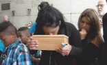 A family grieves their lost baby at a funeral at the crypt at St. Patrick’s Cemetery in New Orleans. Many friends, relatives, and families attended the funeral that day.