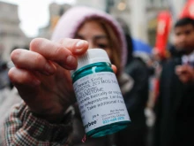 A pro-abortion activist displays abortion pills as she counter-protests during an anti-abortion demonstration on March 25, 2023, in New York City.