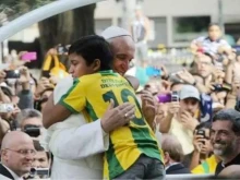 Nathan de Brito hugs Pope Francis during his visit to Rio de Janeiro for World Youth Day 2013.
