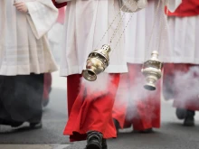 Altar boys swing incense in a procession in Cologne, Germany.