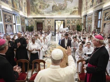Pope Leo XIV greets French altar servers during an audience on Aug. 25, 2025, at the Vatican.