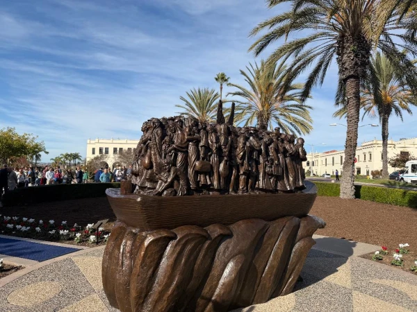 "Angels Unawares," a new sculpture on the campus of the University of San Diego (USD), was installed on Thursday, Dec. 18, 2025. The 8-foot-tall bronze sculpture is a scaled version of one in St. Peter’s Square in Rome that was commissioned by Pope Francis in 2019 and depicts 140 migrants of varying backgrounds on board a boat with a pair of angel wings in their midst. Credit: Jim Graves
