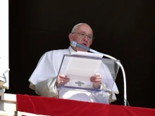 Pope Francis speaks from the window of the Apostolic Palace on Oct. 16, 2022.