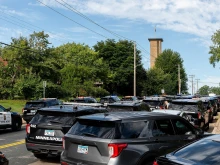 Police cruisers near Annunciation Catholic Church in Minneapolis on Aug. 27, 2025, following a mass shooting that killed two children and injured 17 others, 14 of them children.