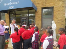 Father Fred Close, pastor of St. Anthony of Padua Catholic Church in Washington, D.C., blesses St. Anthony students after a blessing of the statue.