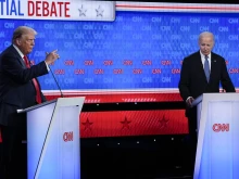 President Joe Biden, right, listens as Republican presidential candidate former President Donald Trump speaks during a presidential debate hosted by CNN, Thursday, June 27, 2024, in Atlanta.