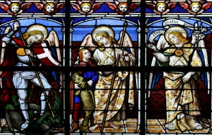 A stained-glass window in St. Sulpice Church in Fougeres, France, depicts (from left to right) the archangels Michael, Raphael, and Gabriel. Credit: Tiberiu Stan/Shutterstock