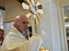 Archbishop Samuel Aquila carries the Eucharist out of the Cathedral Basilica of the Immaculate Conception in Denver on June 9, 2024.