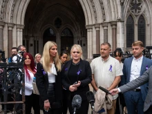 Hollie Dance (center left) and Paul Battersbee (center right)), the mother and father of Archie Battersbee, speak to the media as they leave the Royal Courts of Justice on June 29, 2022 in London, England. Archie's parents ultimately lost their legal fight to keep their son on life support. He died on Aug. 6, 2022.