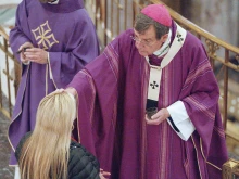 Archbishop Allen H. Vigneron imposes ashes during Ash Wednesday Mass on Feb. 14, 2024, at St. Aloysius Parish in downtown Detroit. Archbishop Vigneron encouraged Catholics to think of this Lenten season as a military campaign proclaiming the kingdom of Christ.