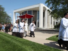 Bishop James Conley leads a eucharistic procession outside Lincoln's Cathedral of the Risen Christ, one of the passport pilgrimage sites.