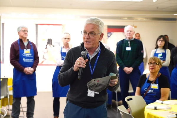 Catholic Charities DC President and CEO James Malloy offers a prayer before a Thanksgiving meal Nov. 25, 2025. Credit: Courtesy of Ralph Alswang for Catholic Charities DC.