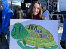 A young pro-life marcher carries a sign reading, “Save the baby humans,” at the March for Life in Washington, D.C., on Jan. 20, 2023.