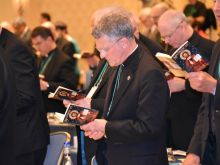 Bishops pray during the Fall General Assembly of the USCCB. 