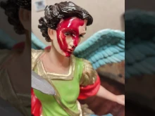 A statue of St. Michael the Archangel with a liquid 'similar to red nail polish' on its head.
